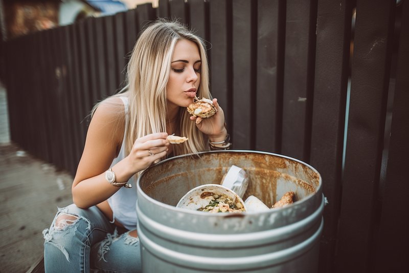 Woman double fisted eating trash